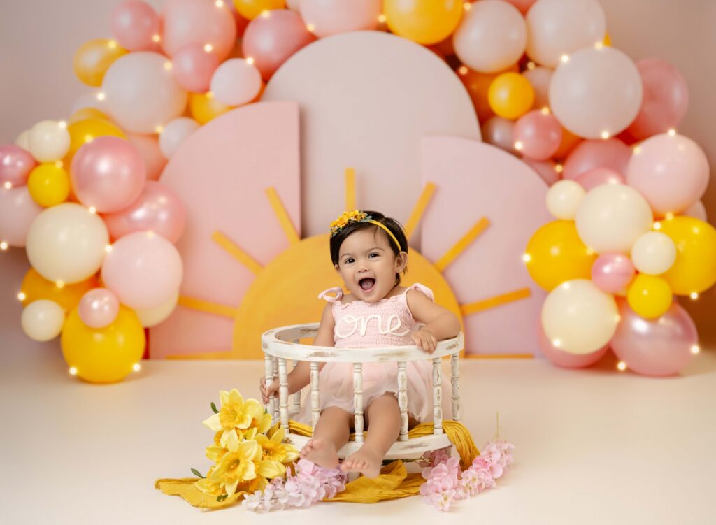 baby in basket smiling for birthday photos