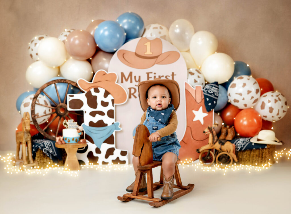 Boy on wooden horse for my 1st rodeo birthday photoshoot.