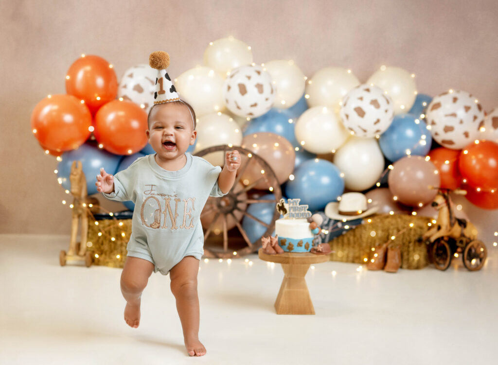 Baby boy running off my first rodeo set and smiling.