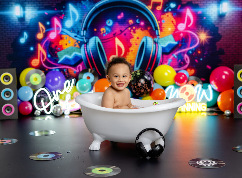 Baby in bath tub on DJ theme cake smash set.