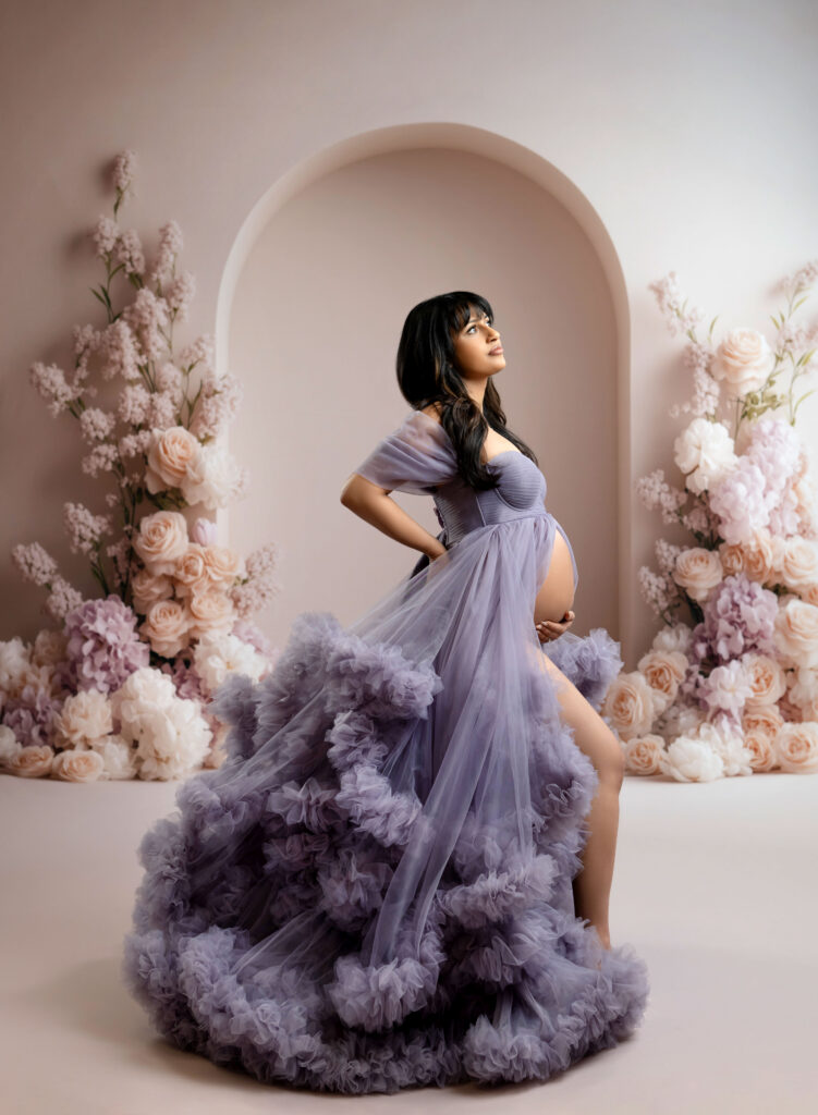 Pregnant women in lavender gown showing off baby bump.