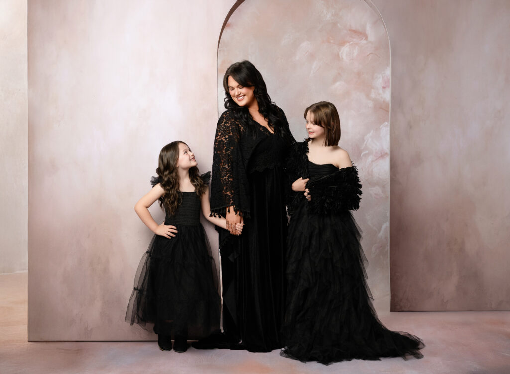 Mom with 2 daughters posing for portrait. Atlanta Family Photography Studio.