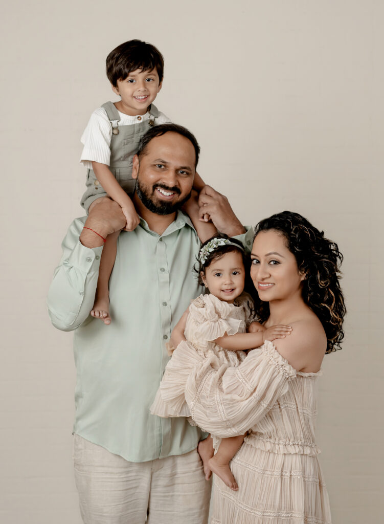 Family of 4 posing for studio family portraits. Atlanta Family Photographer.