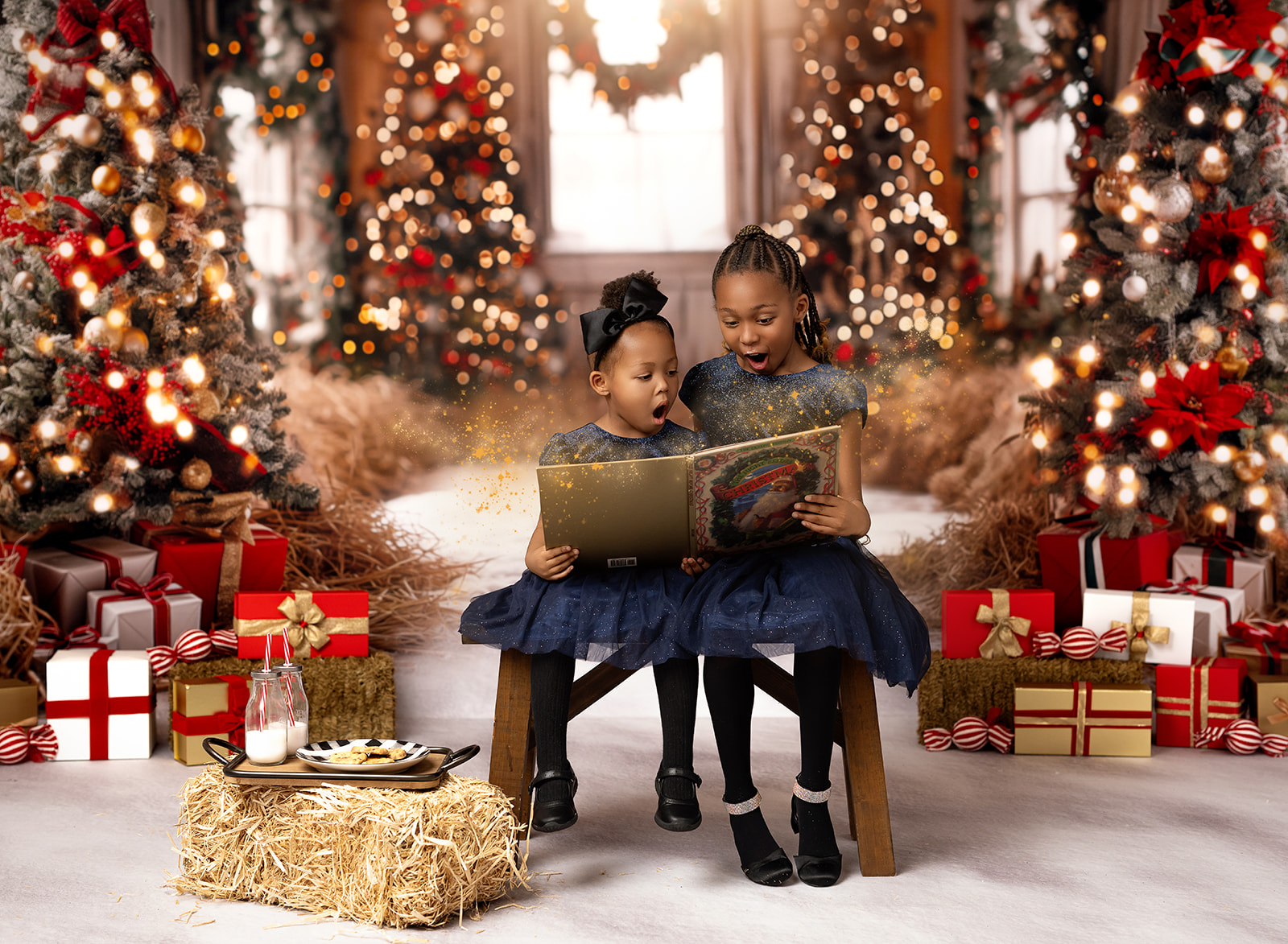 Two girls reading Santa book with gold majic fairy dust coming out of the book.
