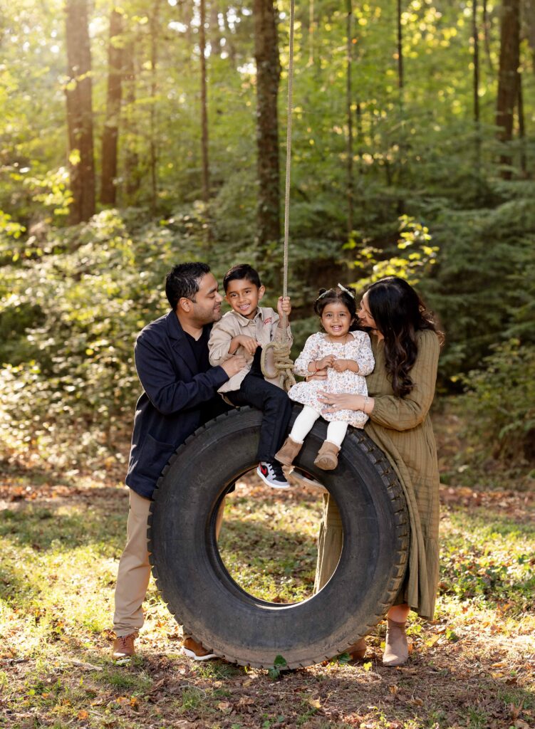 Family taking photos on a tire swing at Mayberry Acres near Atlanta GA.