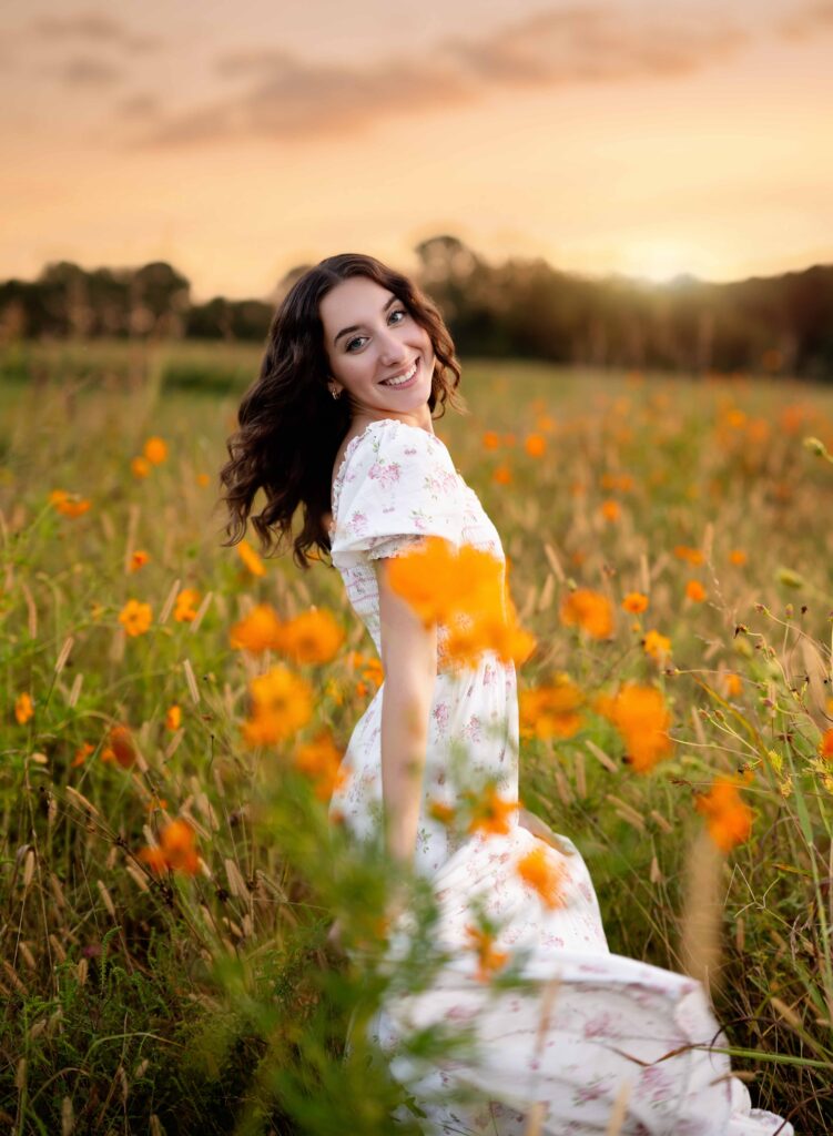 Teen twirling in wildflower field near Atlanta GA.