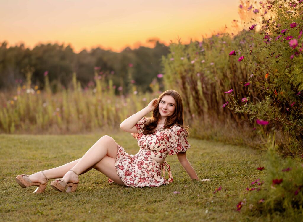 girl taking Senior photos near wildflower field