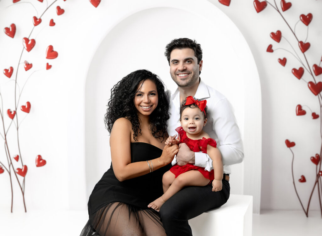 Mom, Dad and baby in red taking a Valentines day photo at Atlanta photography studio.